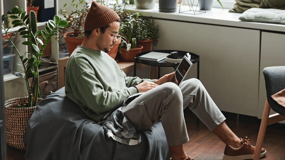 man working on his laptop in a green office