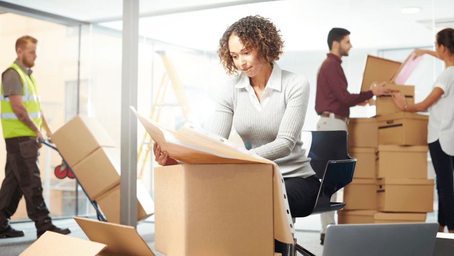 woman reading a paper while moving out