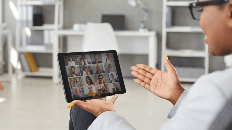 Black woman having online meeting with her business team via video call on tablet