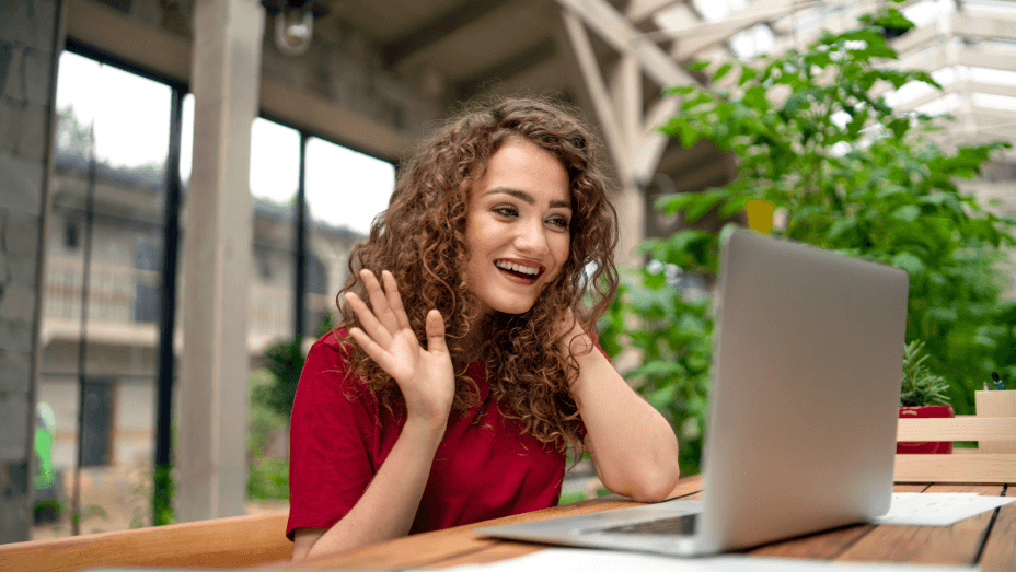 Young woman sitting indoors in green office, conference business call concept