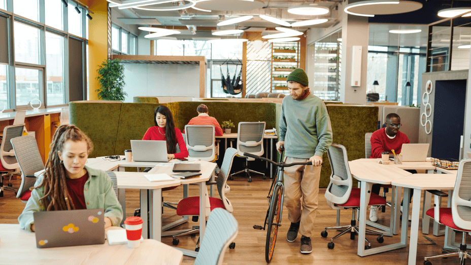 man with a bicycle in a sustainable office