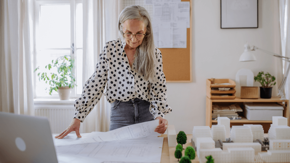 woman looking at blueprints in a sustainable office