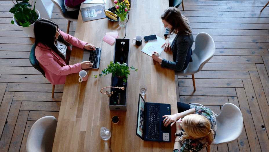 three woman working on laptops in the office