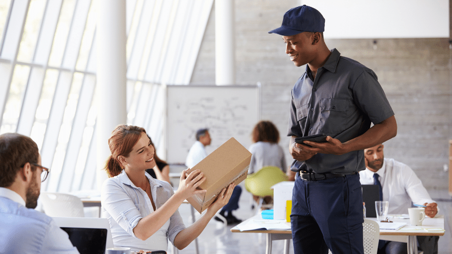 Delivery man is delivering personal packages in the office