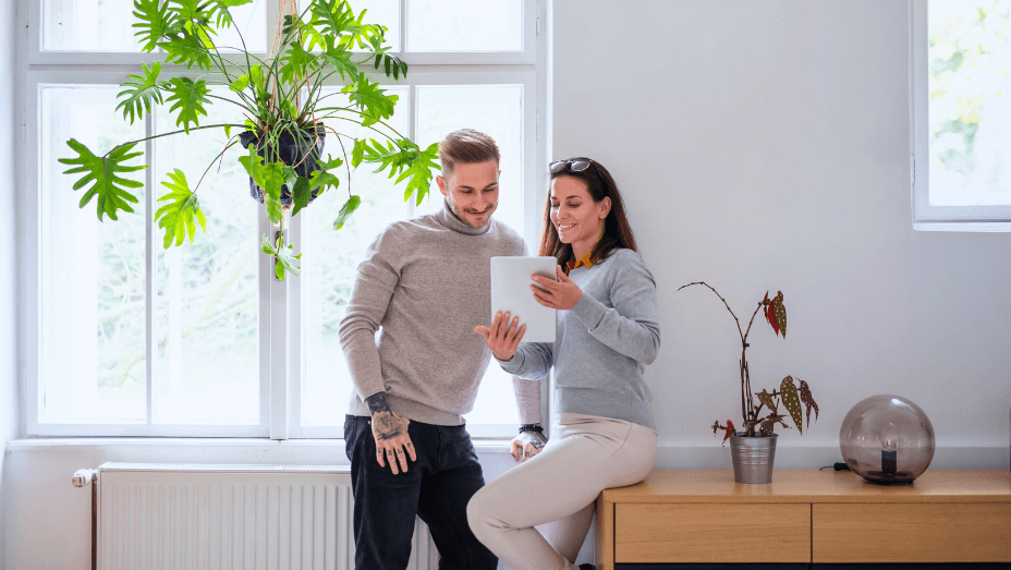 businesspeople-with-tablet-standing-indoors-in-office