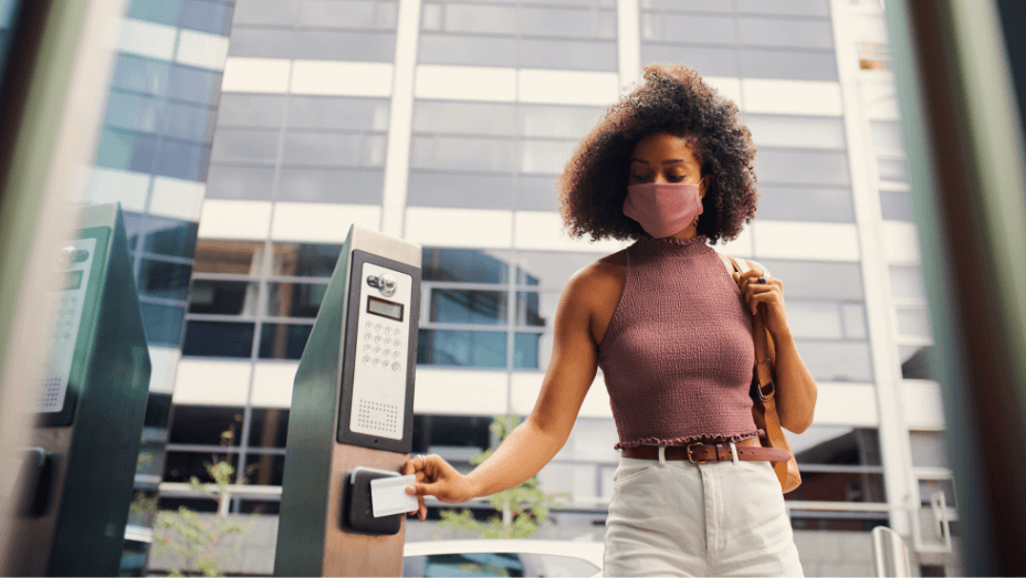 businesswoman-in-face-mask-swipes-security-pass-
