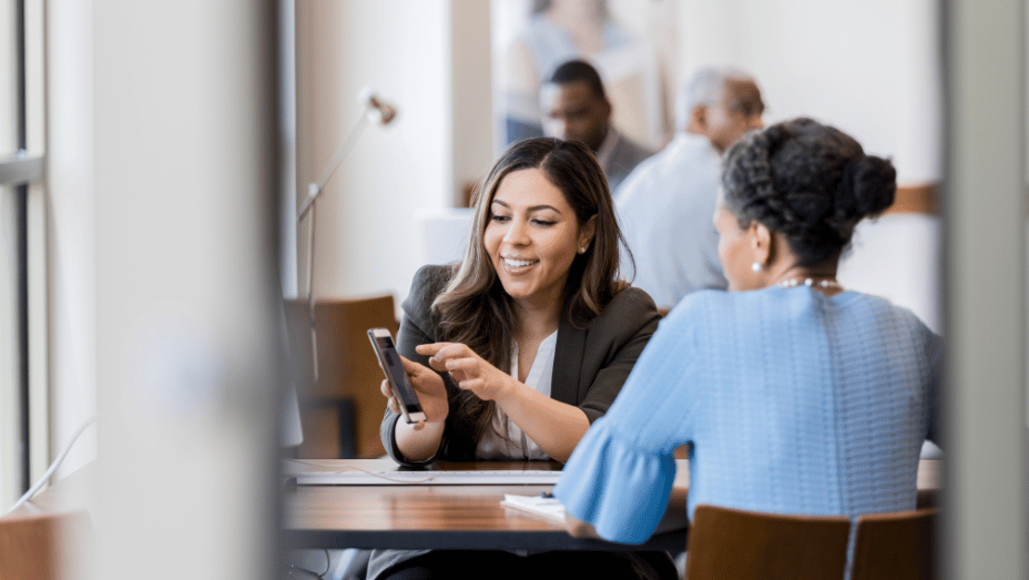 colleagues using a new workplace platform on mobile phone