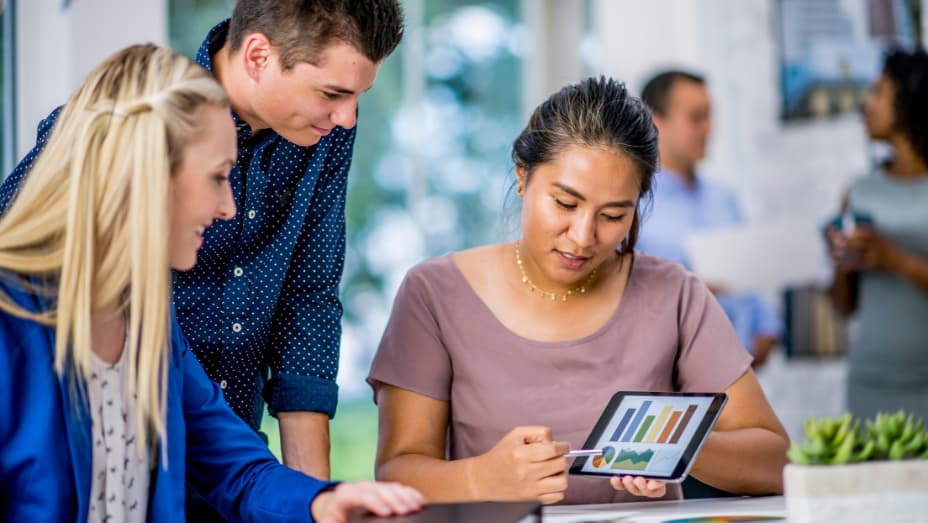 employees evaluating office hoteling data