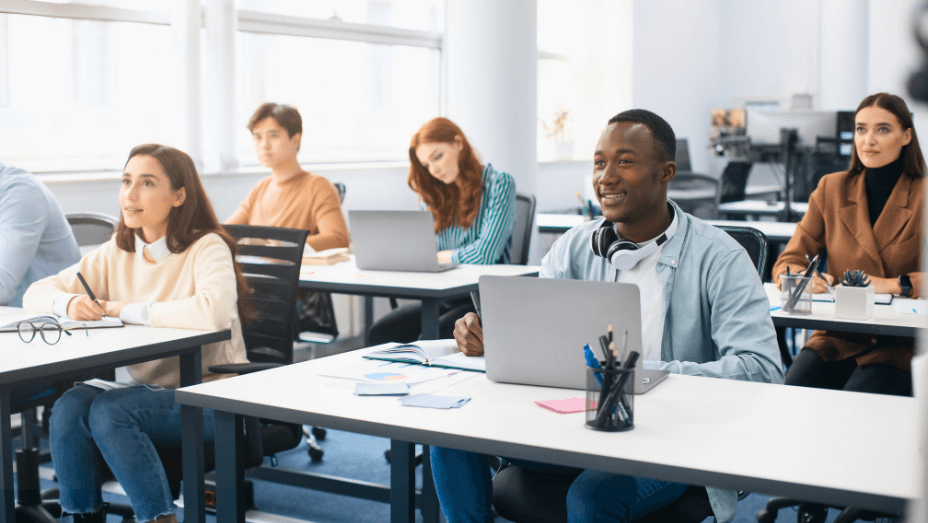 group-of-international-employees-using-laptop-listening to the teacher