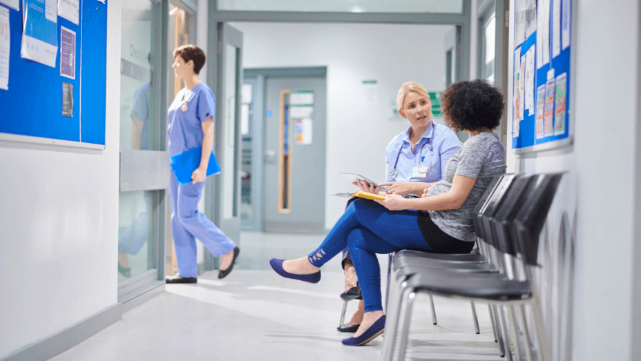 healthcare workers is talking to a patient in a clinic