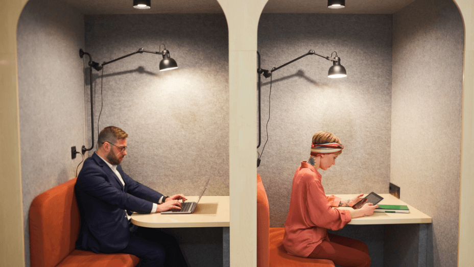 two-business-people-working-in-cafe-booths