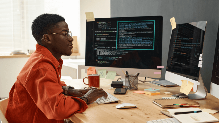 young-serious-it-engineer-in-smart-orange-shirt