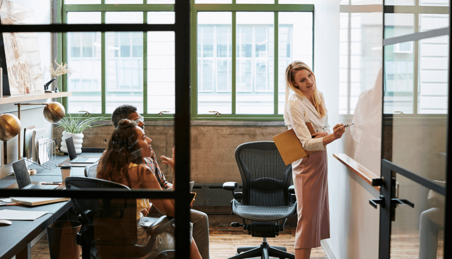 woman writing on a board at work