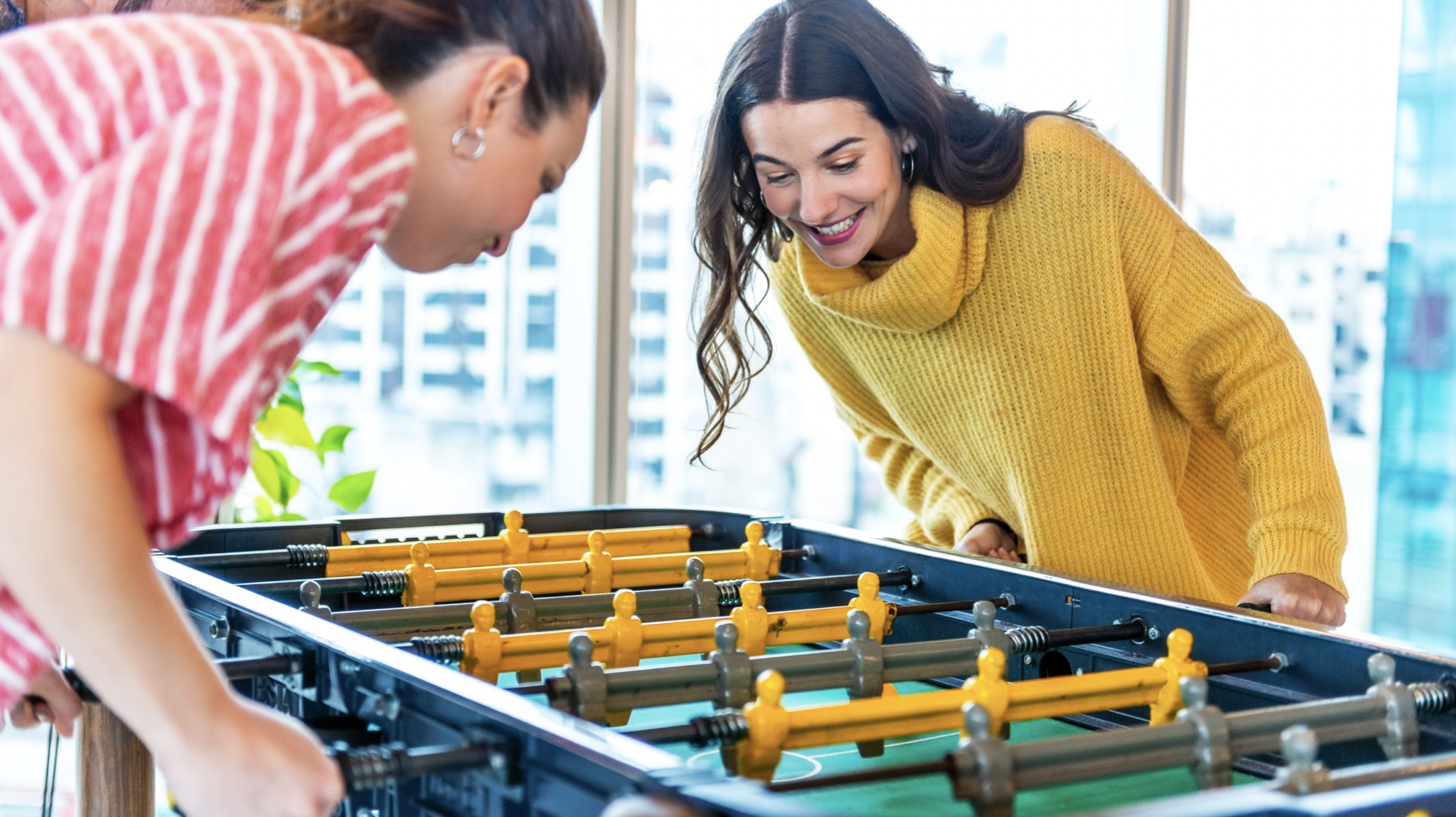 colleagues playing foosball