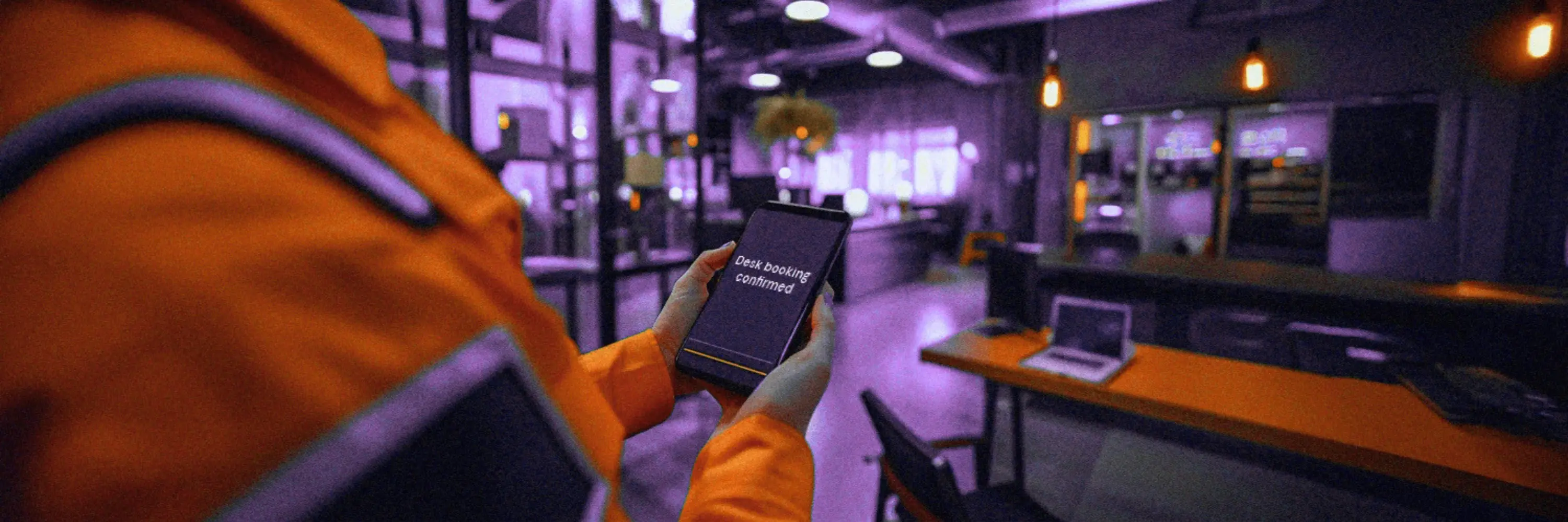 Person using a mobile desk booking app in an office