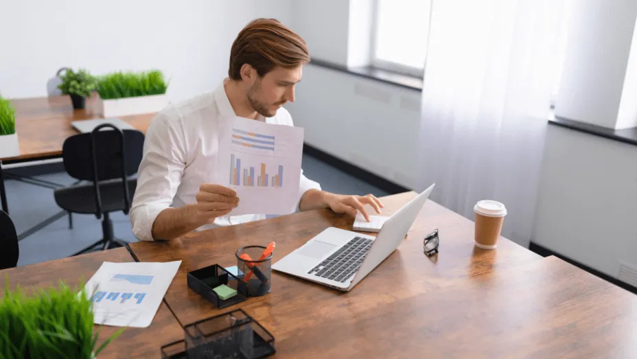 businessman in a stylish office on a laptop calculator