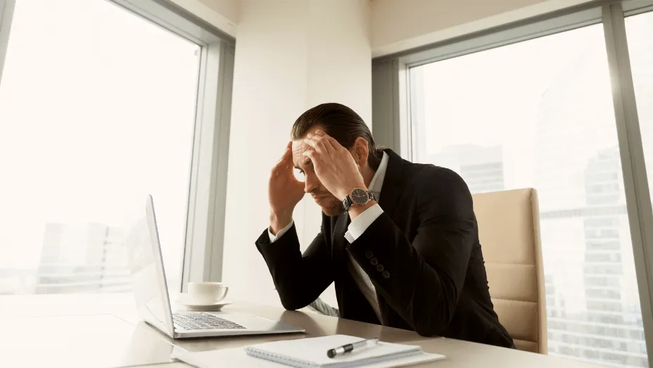 exhausted man working on computer