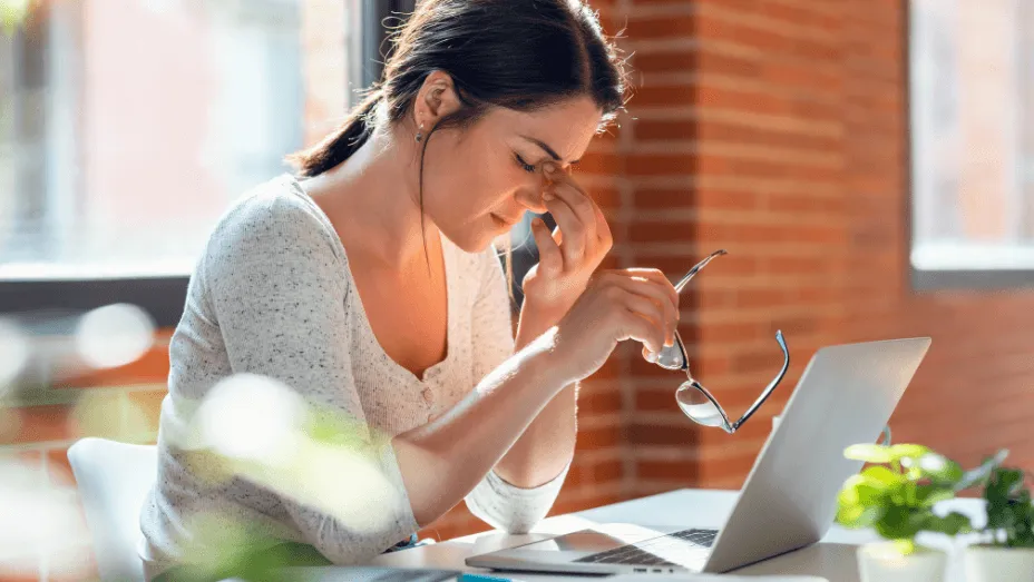 Tired business woman with headache looking uncomfortable