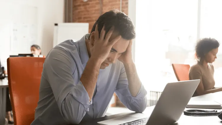 Tired employee in a virtual meeting