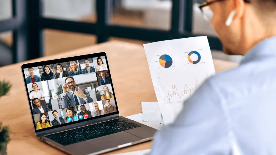 man working in the office having a call with his hybrid team