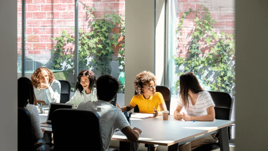 multiracial group of colleagues chat in office