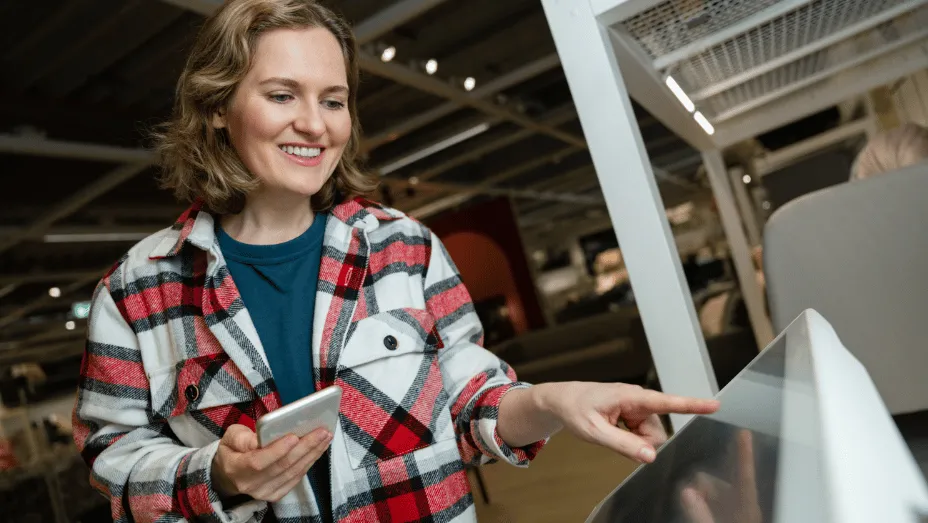 A woman using a digital system for visitor check-ins