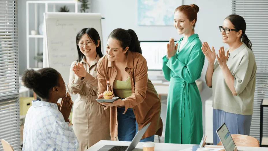 Businesswomen congratulating their colleague at office