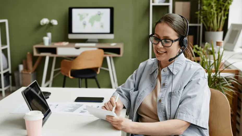 businesswoman making notes during online call
