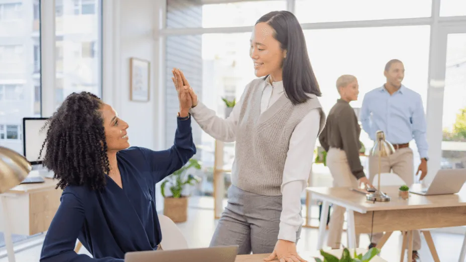 Business women high five