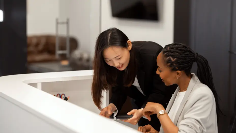 Reception team reviewing visitor management tablet check-in setup