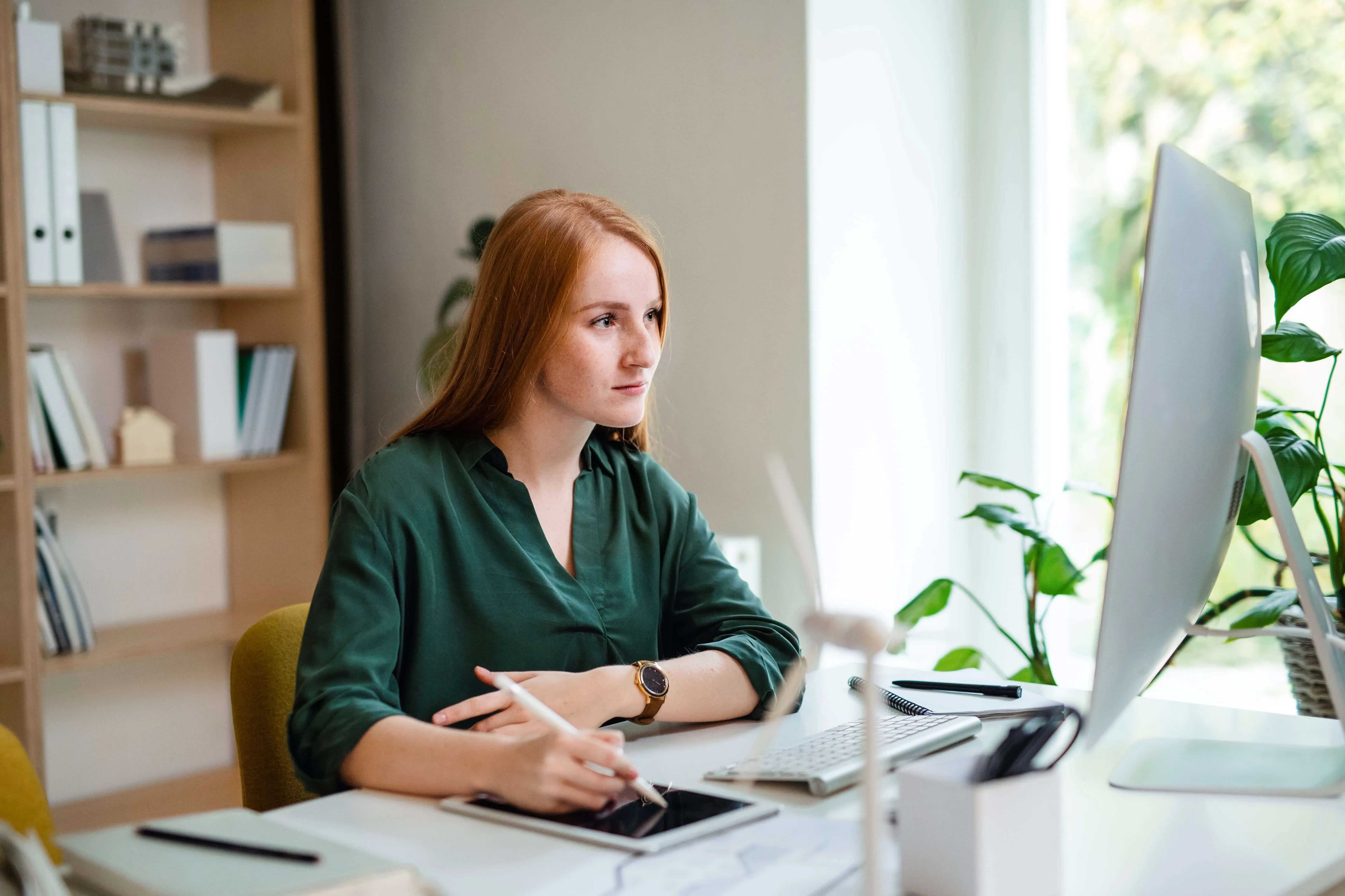 young businesswoman sitting at the desk indoors